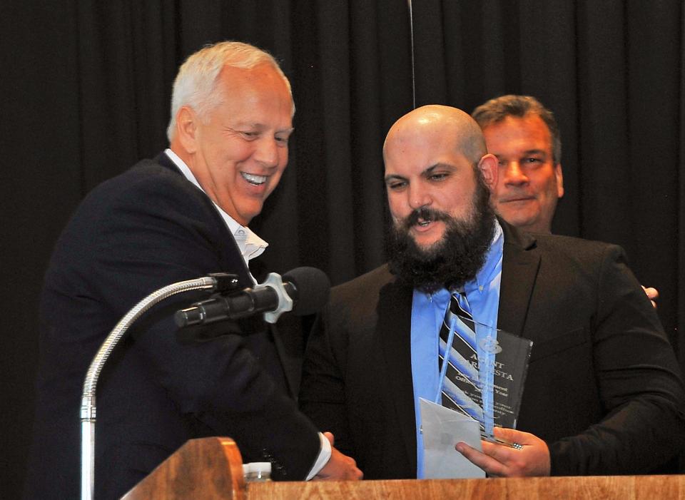 Charlie Hardman, left, retired Wayne County Sheriff’s Office captain and Wooster Exchange Club member, presents senior Medway agent Carl Festa with the Law Enforcement Officer of the Year award. (PROVIDED BY DAN STARCHER)