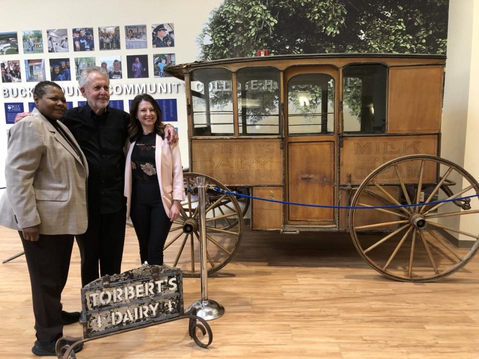 Bucks County Community College President Felicia Ganther (left) joins Gene Epstein and Christina Kahmar-McGinley, executive director of the BCCC Foundation, at the college's display for the historical Torbert's Dairy Wagon that represents the history of dairy farming and milk delivery in Bucks County.