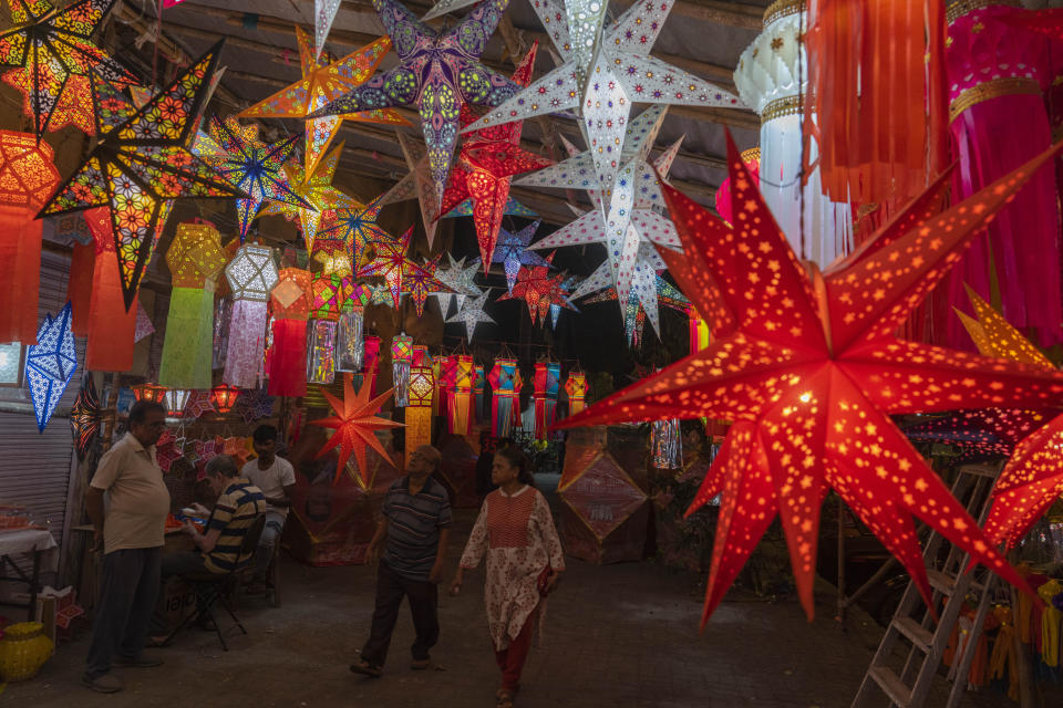 People look at lanterns displayed for sale at roadside stalls ahead of Diwali festival in Mumbai, India, Sunday, Nov. 5, 2023. (AP Photo/Rafiq Maqbool)