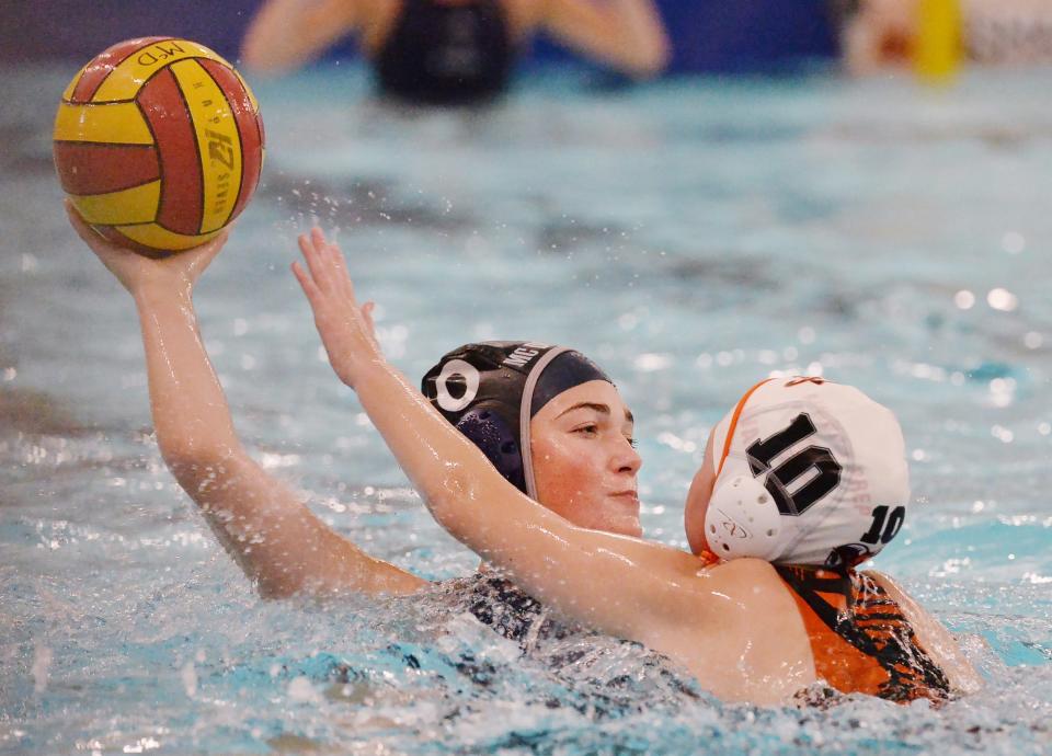McDowell's Clara Gibson, left, is defended by Cathedral Prep's Savannah Wierzchowski during a water polo match in Millcreek Township.