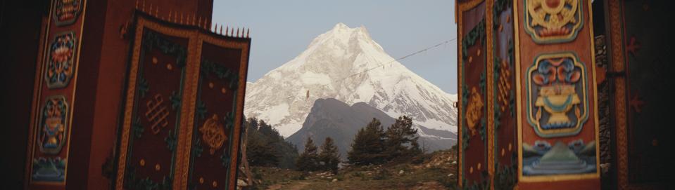 The Creator; a painting of a temple in a mountain