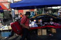 A stall with security elements is seen in the street market, during a preventive quarantine after the outbreak of the coronavirus disease (COVID-19), in Santiago