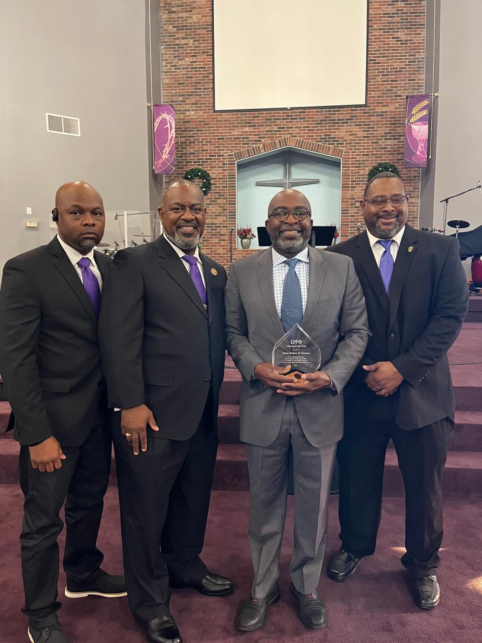 Rodney B. Freeman of Clover, South Carolina standing beside Jonathan Strong, Maury Williams and Andre Corbett who are members of the Epsilon Upsilon Alumnus chapter of Omega Psi Phi Fraternity, Inc. Freeman received the 71st annual "Outstanding Citizen of the Year," award for his leadership and community service as a pastor in Gastonia's Mount Zion Restoration Church, serving food to more than 100,000 residents throughout Gaston County in need via the church's food pantry.