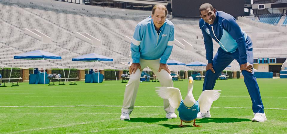 Nick Saban, the Aflac duck and Deion Sanders pose for a picture on the set of the insurance companies' new campaign for the 2021 college football season.