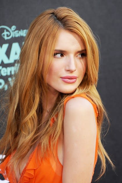 <p><strong>October 2014</strong></p> <p>Bella amps up the volume with beachy waves and a distinct lack of bangs. Makeup-wise, she switches it up with shimmery gold shadow and bold, raspberry lips.</p>