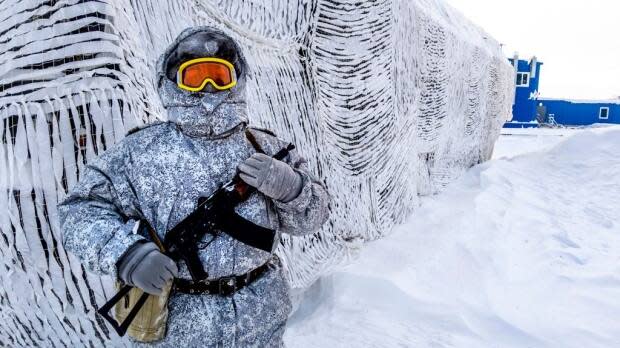 A soldier holds a machine gun as he patrols the Russian northern military base on Kotelny island, beyond the Arctic Circle, on April 3, 2019.