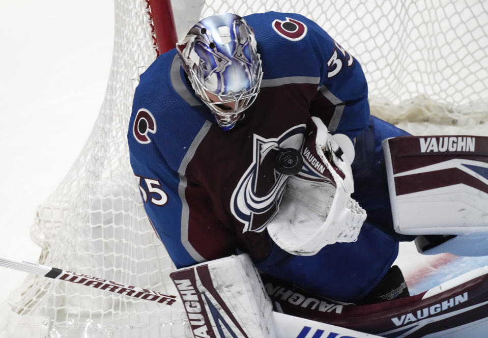 Colorado Avalanche goaltender Darcy Kuemper makes a glove save on a Chicago Blackhawks shot during the second period of an NHL hockey game Wednesday, Oct. 13, 2021, in Denver. (AP Photo/David Zalubowski)