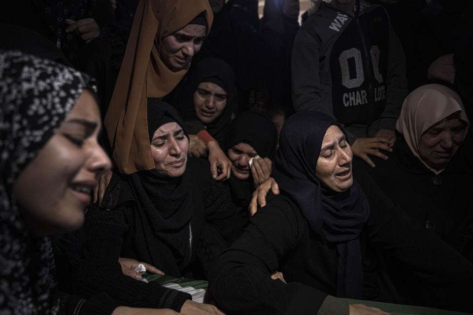 FILE, Palestinian women weep during the funeral of Mohammed al-Shaer, one of eight Palestinians who drowned off the coast of Tunisia, in Rafah, southern Gaza Strip, Sunday, Dec. 18, 2022. As a rising number of Gazans are drowning in the sea en route to a better life in Europe, Gaza's Hamas rulers are moving to comfortable life in upscale Middle East hotels, prompted a rare outpouring of anger at home, where the economy collapses and 2.3 million people remain effectively trapped in the tiny, conflict-scarred territory. (AP Photo/Fatima Shbair, File)