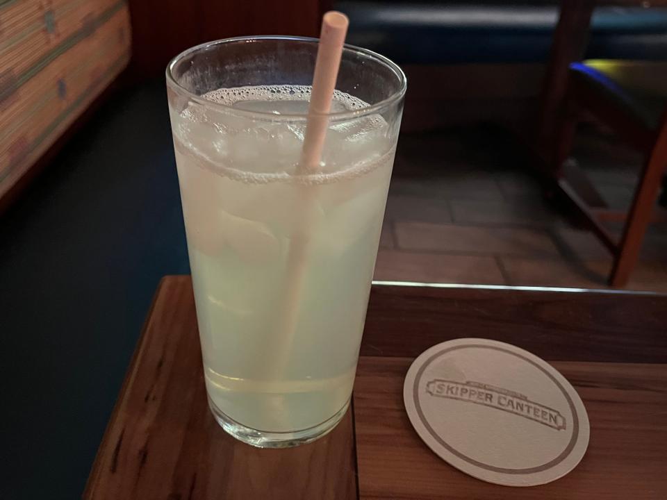 themed skipper canteen coaster next to glass of lemonade at the magoc kingdom restaurant