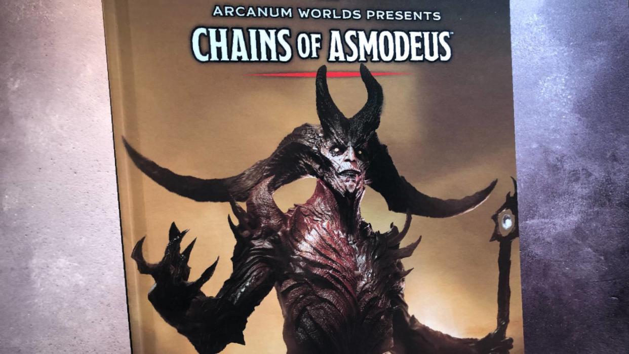  Cover of the hardback Chains of Asmodeus book against a gray background. 
