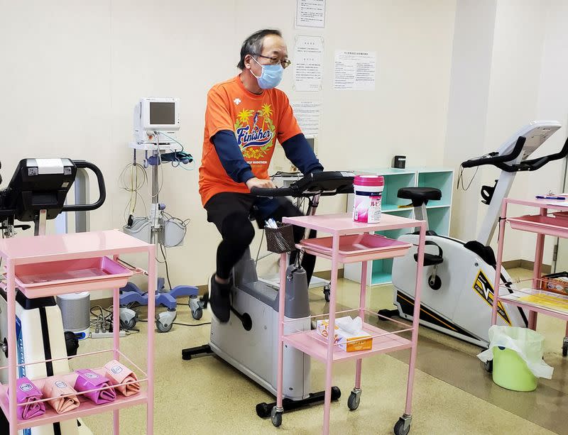 Manabu Yoneshima works out by using bicycle machine in his hospital's rehabilitation room in Tsuruga