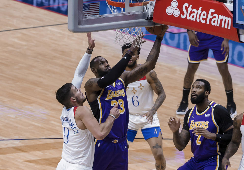 Los Angeles Lakers forward LeBron James (23) shoots over New Orleans Pelicans center Willy Hernangomez (9) in the first quarter of an NBA basketball game in New Orleans, Sunday, May 16, 2021. (AP Photo/Derick Hingle)