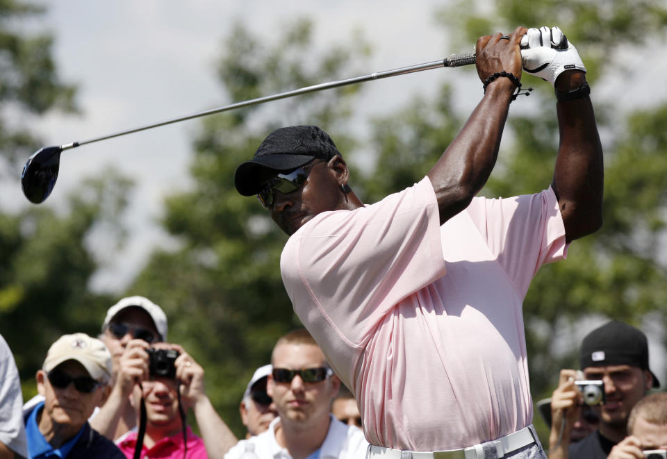 Former NBA basketball player Michael Jordan tees off during the inaugural Mike Weir Charity Classic golf tournament at Glen Abbey Golf Club in Oakville, Ontario July 20, 2009.  REUTERS/ Mike Cassese   (CANADA SPORT GOLF BASKETBALL IMAGES OF THE DAY)