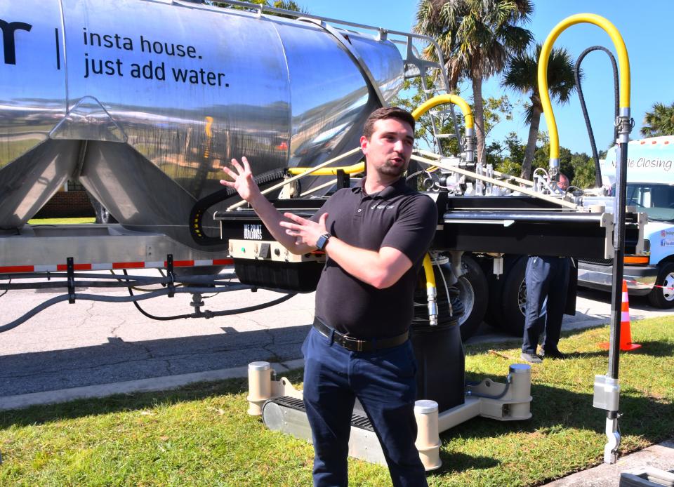 Trevor Ragno, Apis Cor director of construction, talks about his company's robots during Thursday's 3D-printed home complex groundbreaking ceremony on Lipscomb Street in Melbourne.