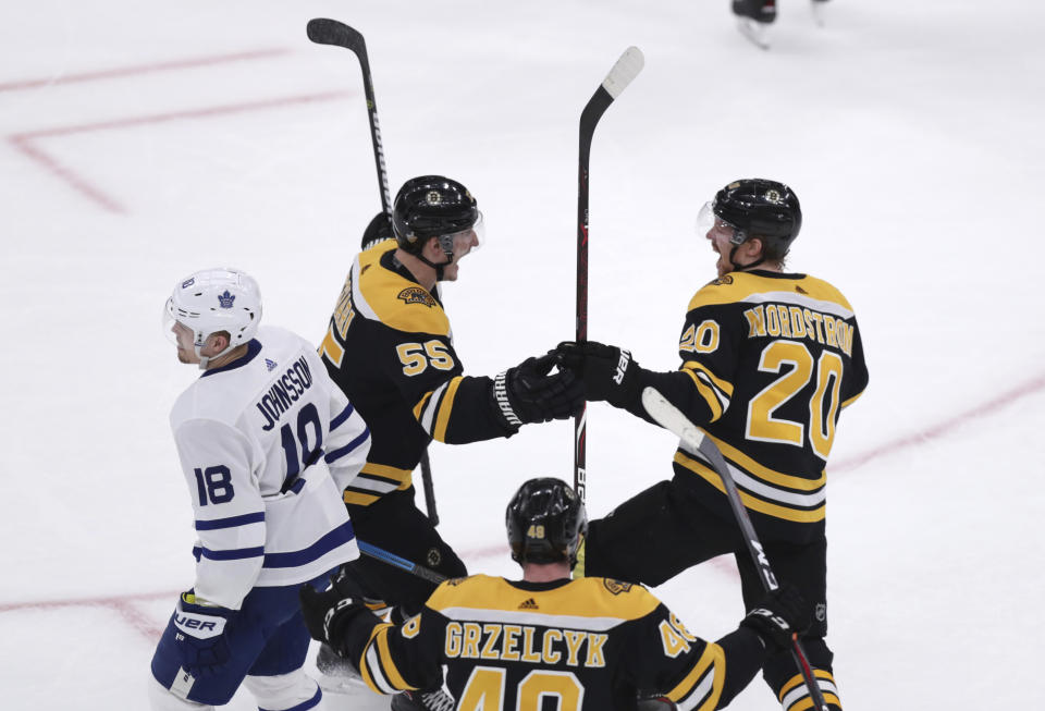 Boston Bruins center Joakim Nordstrom (20) is congratulated by Noel Acciari (55) after his goal against the Toronto Maple Leafs during the first period of Game 7 of an NHL hockey first-round playoff series, Tuesday, April 23, 2019, in Boston. At left is Toronto Maple Leafs left wing Andreas Johnsson (18), in foreground is Boston Bruins defenseman Matt Grzelcyk (48). (AP Photo/Charles Krupa)