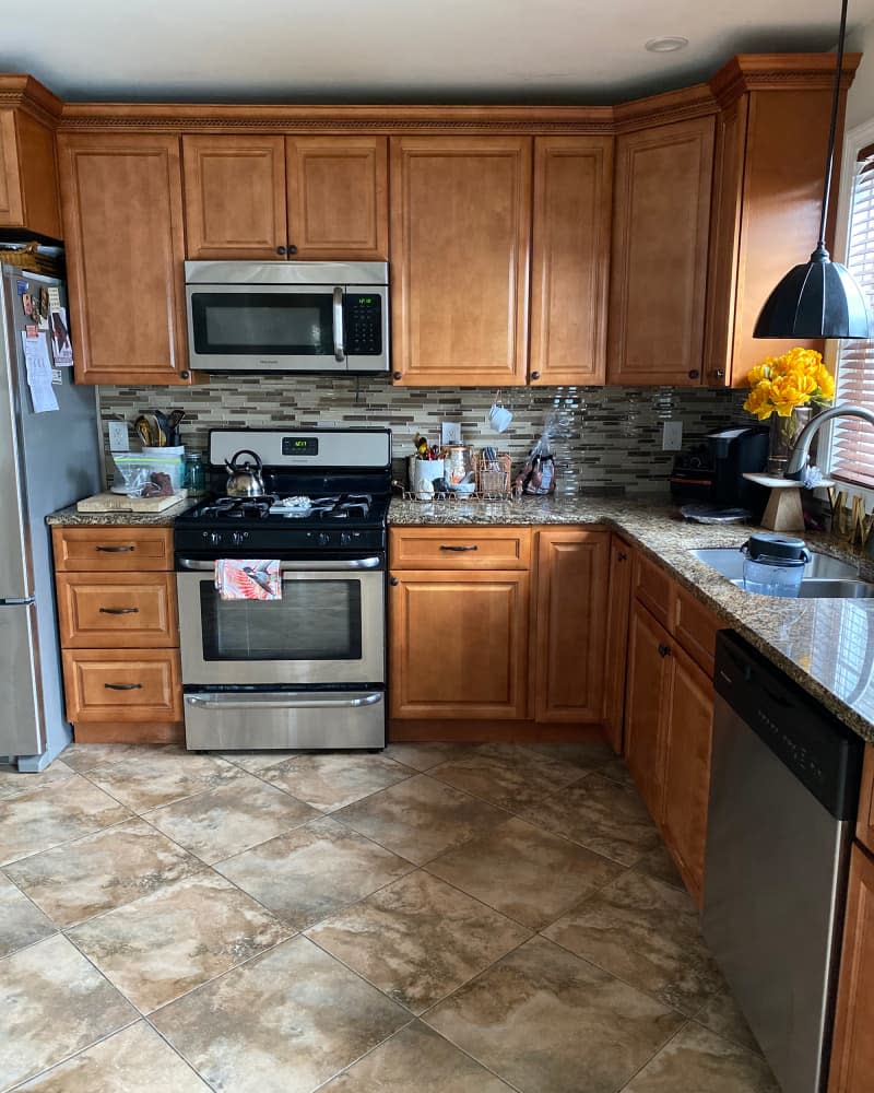 Kitchen with brown tile backsplash before renovation.