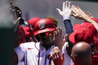 Washington Nationals' Josh Bell celebrates his two-run homer with his teammates during the first inning of a baseball game against the Philadelphia Phillies at Nationals Park, Thursday, May 13, 2021, in Washington. (AP Photo/Alex Brandon)