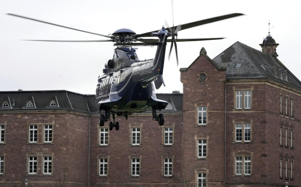 A police helicopter with a suspect arrives in Karlsruhe, Germany, Wednesday, Dec. 7, 2022 close the federal prosecutor's office. Thousands of police officers carried out raids across much of Germany on Wednesday against suspected far-right extremists who allegedly sought to overthrow the government in an armed coup. Officials said 25 people were detained. (AP Photo/Michael Probst)