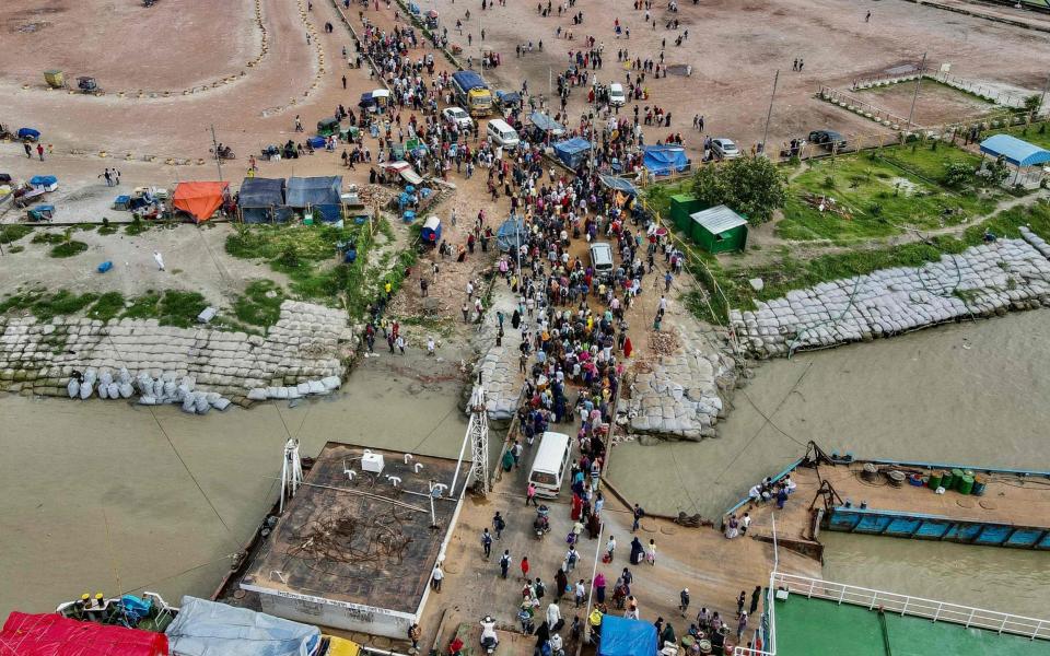 People disembark from a ferry in Sreenagar to resume and return to their work areas, after the Bangladesh government relaxed the lockdown for all export oriented factories  - MUNIR UZ ZAMAN/AFP