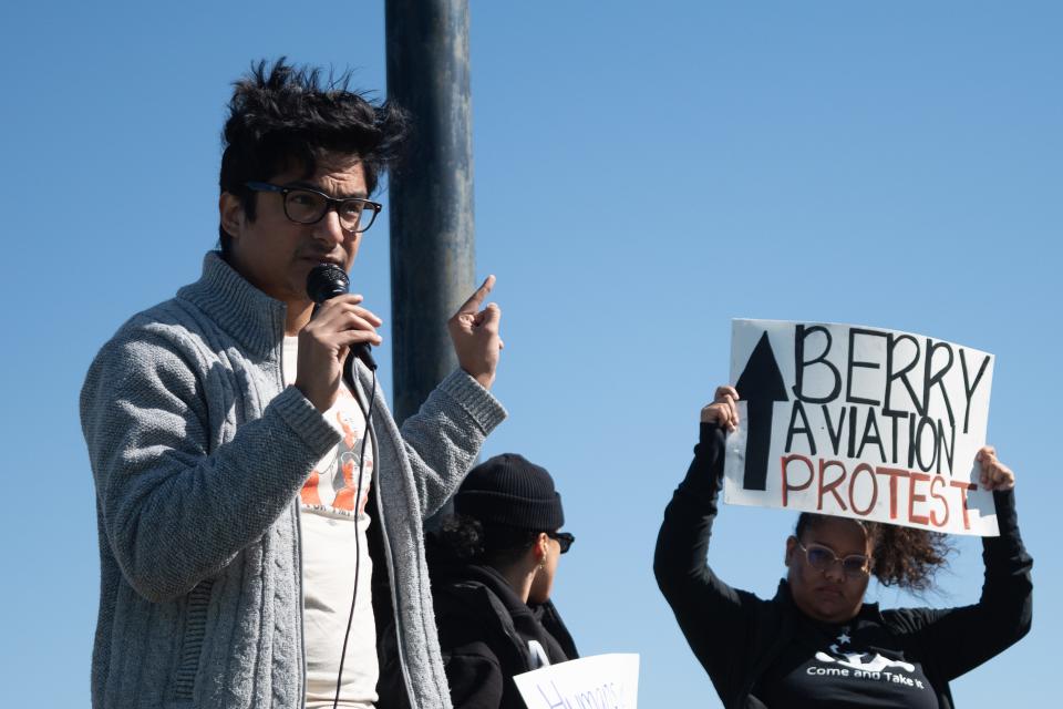 Roberto Alejandro Lopez, a community organizer for Texas Civil Rights Project, speaks during the Oct. 15 protest outside of Berry Aviation. The protesters called for the San Marcos-based company to issue a public apology over migrant flights and "cease participating in a political game where humans are used as pawns."