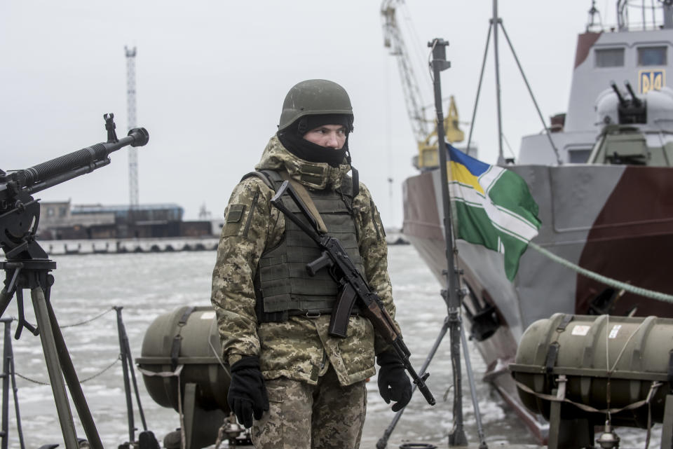 A Ukrainian serviceman stands on board a coast guard ship in the Sea of Azov port of Mariupol, eastern Ukraine, Monday, Dec. 3, 2018. The Ukrainian military has been on increased readiness as part of martial law introduced in the country in the wake of the Nov. 25, 2018 incident in the Sea of Azov, in which the Russian coast guard fired upon and seized three Ukrainian navy vessels along with their crews. (AP Photo/Evgeniy Maloletka)