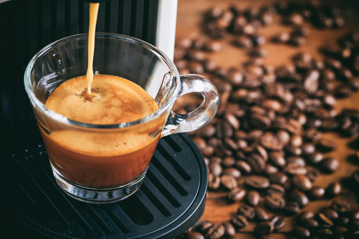 Espresso coffee machine preparation on a wooden table