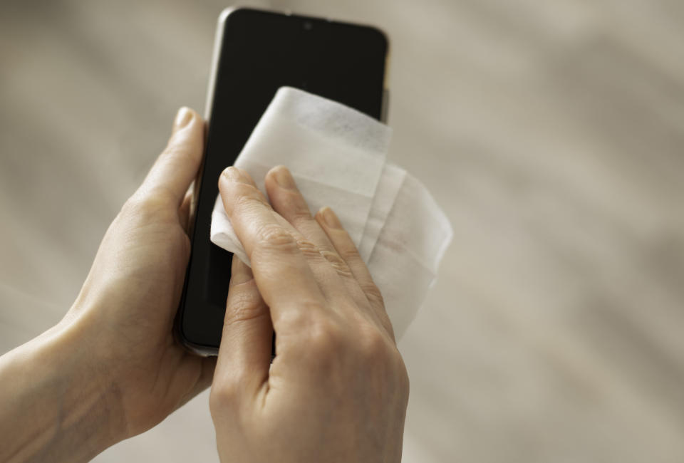 Make sure you're regularly cleaning your phone. (Photo: Getty)