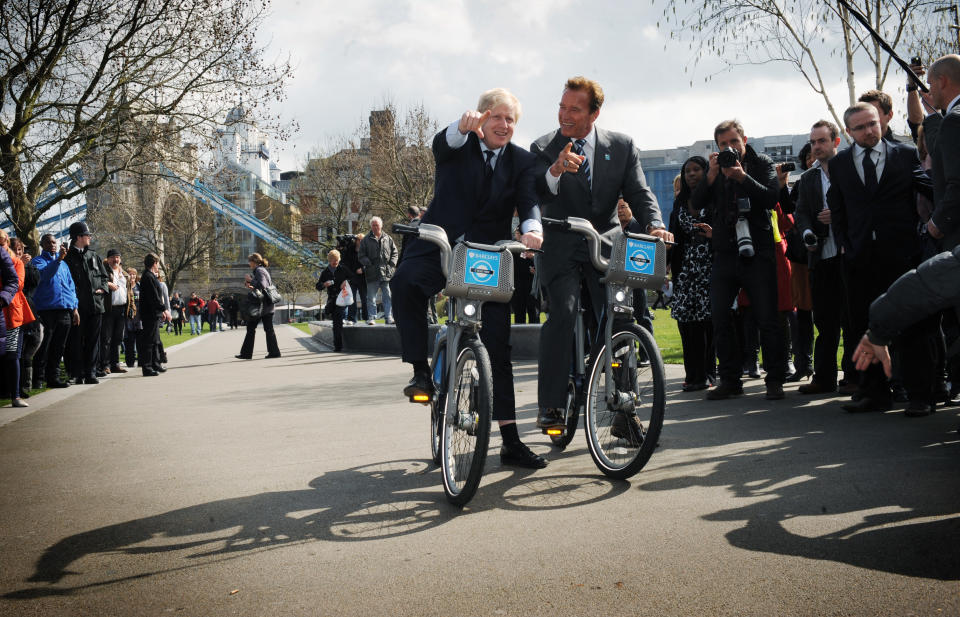 London Mayor Boris Johnson takes former Governor of California Arnold Schwarzenegger (right) for a ride on one of his 'Boris bikes' during his visit to City Hall in London. PRESS ASSOCIATION Photo. Picture date: Thursday March 31, 2011. Photo credit should read: Stefan Rousseau/PA Wire