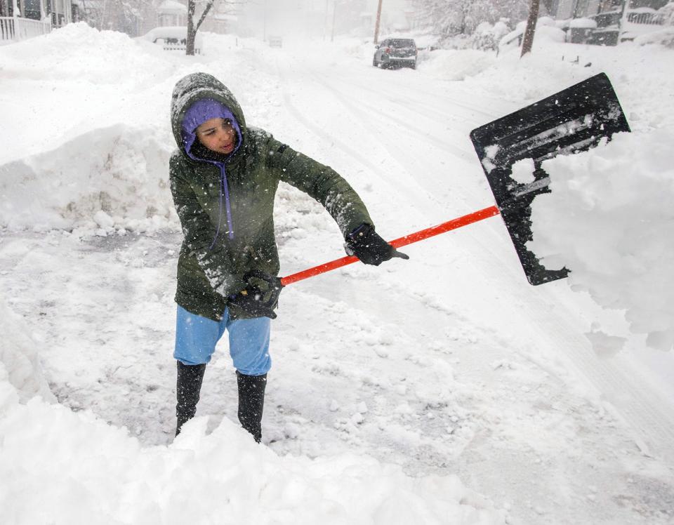 Kimberly Baez digs out her driveway in Gardner as more than a foot of snow has fallen in Northern Worcester County Tuesday.