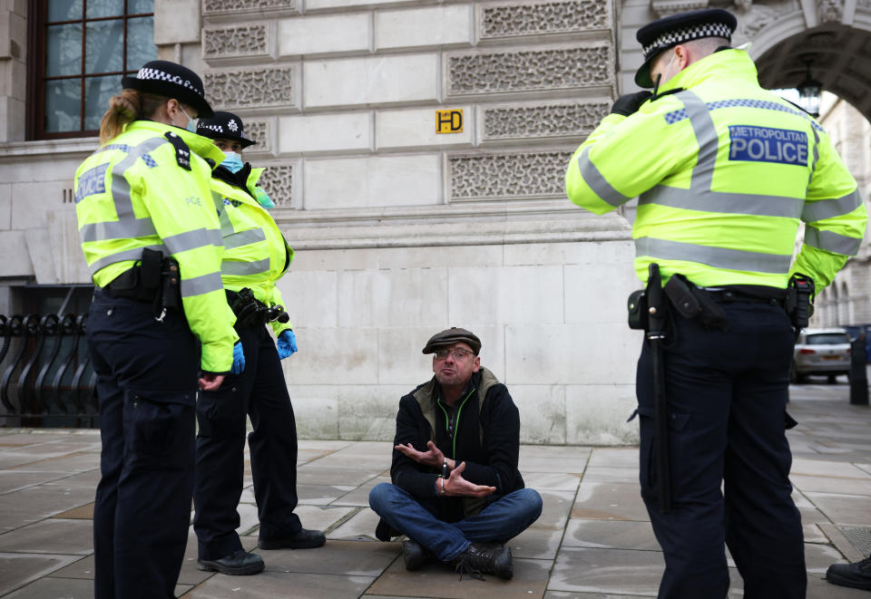 LONDON, ENGLAND - JANUARY 06: An anti-lockdown protester is arrested by police officers in Parliament Square outside the House of Commons on January 6, 2021 in London, England. The UK Parliament has been recalled today to debate and vote on the new regulations needed to reimpose the England-wide lockdown that was announced by Prime Minister Boris Johnson on Monday night. (Photo by Dan Kitwood/Getty Images)