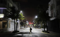 <p>A lone pedestrian walks through the usual bustling South Beach ahead of Hurricane Irma in Miami Beach, Fla., Friday, Sept. 8, 2017. (Photo: David Goldman/AP) </p>