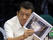 Chinese-born Filipino businessman Kam Sin Wong presents a document during the money laundering hearing at Senate in Manila March 29, 2016. REUTERS/Romeo Ranoco