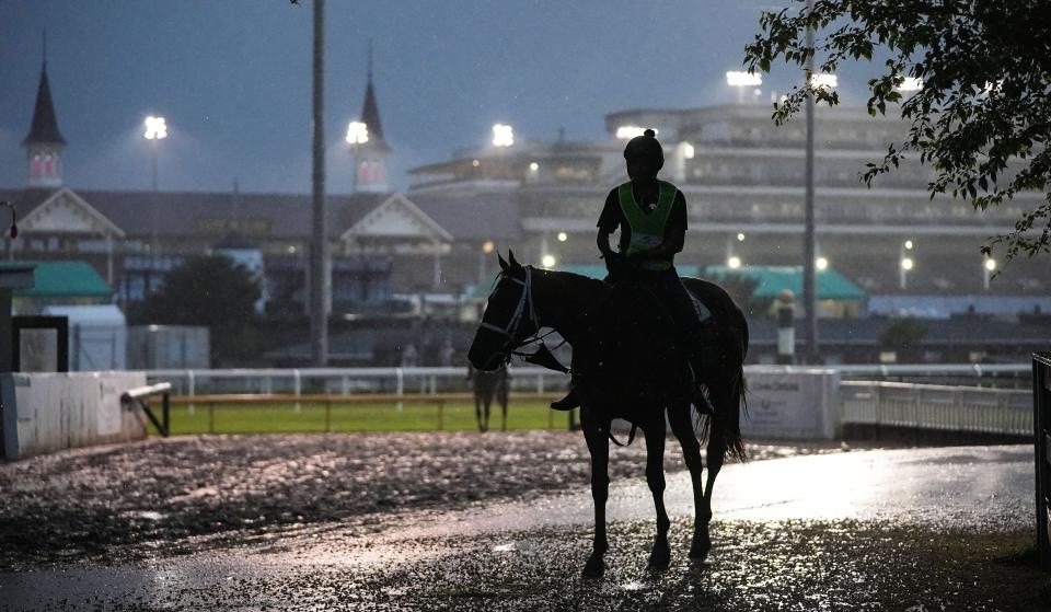 Exercise riders ride off the track after morning workout Friday, May 3, 2024, ahead of the 150th running of the Kentucky Oaks at Churchill Downs in Louisville, Kentucky.