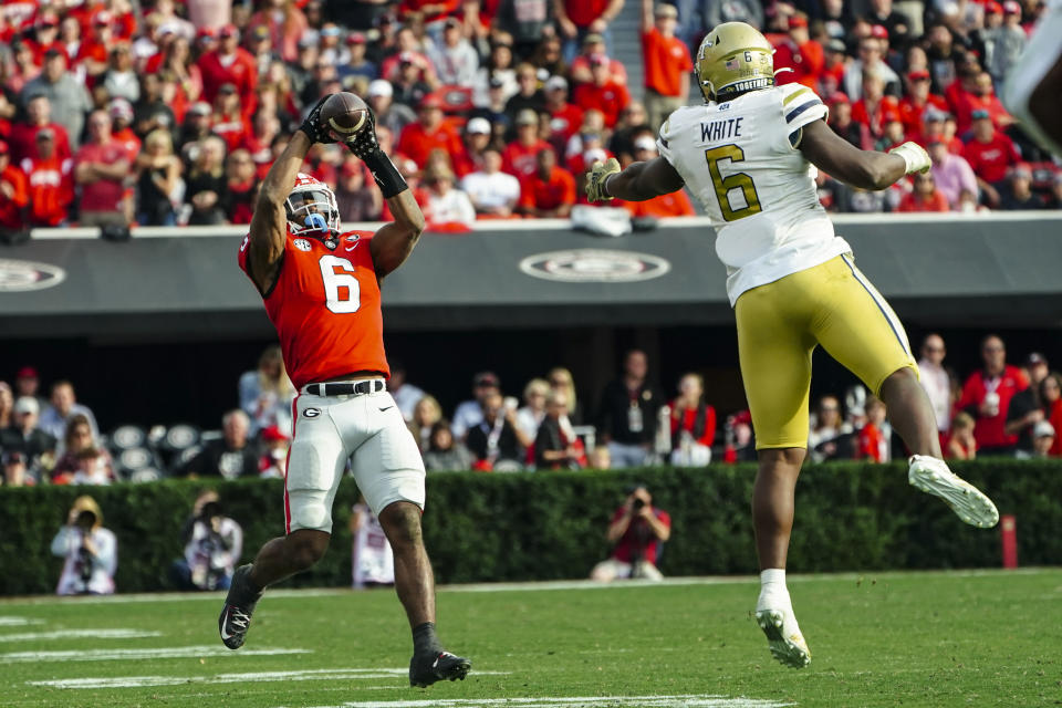 Georgia running back Kenny McIntosh (6) makes a catch for a big gain as Georgia Tech defensive end Keion White (6) defends during the second half of an NCAA college football game Saturday, Nov. 26, 2022 in Athens, Ga. (AP Photo/John Bazemore)