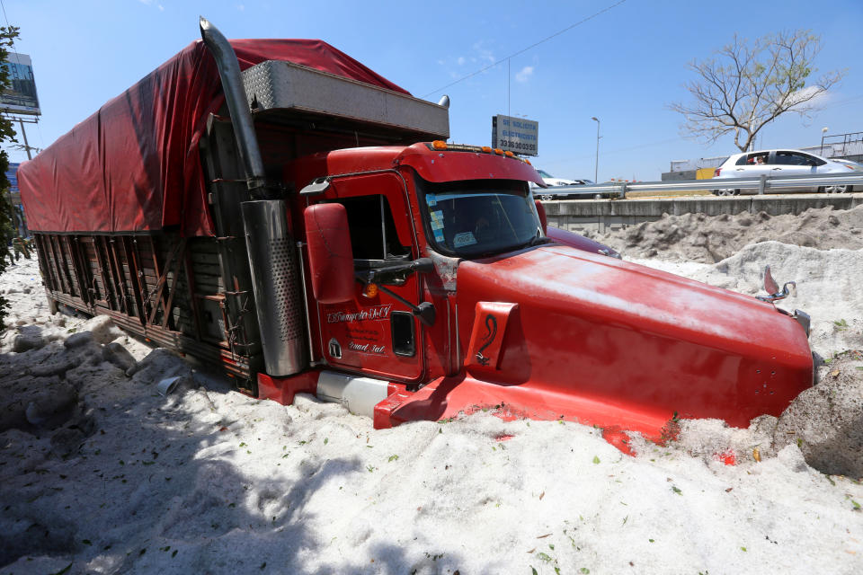 A truck is buried in ice after a heavy storm of rain and hail which affected some areas of the city in ??Guadalajara, Mexico June 30, 2019. REUTERS/Fernando Carranza