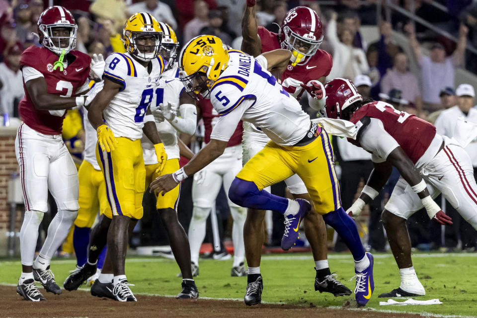 LSU quarterback Jayden Daniels (5) runs the ball for a touchdown against Alabama during the first half of an NCAA college football game, Saturday, Nov. 4, 2023, in Tuscaloosa, Ala. (AP Photo/Vasha Hunt)