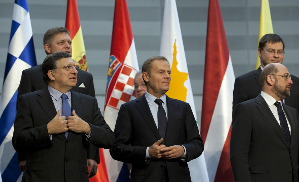 European Commission President Jose Manuel Barroso, left, Poland's Prime Minister Donald Tusk, center, and European Parliament President Martin Schultz, right, stand in front of Slovakian Prime Minister Robert Fico, rear left, Latvian Prime Minister Valdis Dombrovskis, rear right, during a group photo at a Friends of Cohesion meeting at the European Parliament in Brussels on Tuesday, Nov. 13, 2012. EU leaders met on Tuesday to discuss tactics ahead of the battle for the EU budget. (AP Photo/Virginia Mayo)