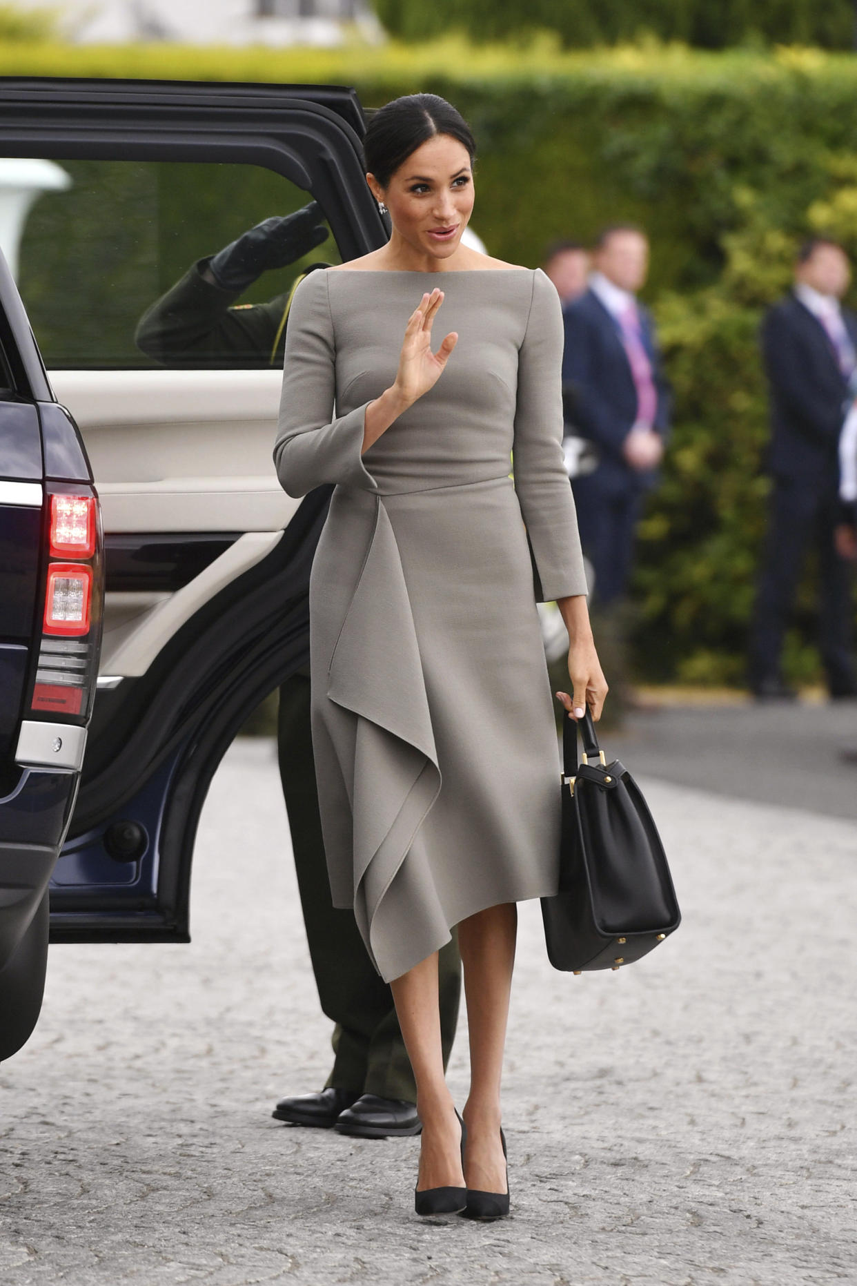 The Duchess of Sussex opted for a neutral palette with her Roland Mouret dress and black Fendi bag. (Photo: Joe Giddens/PA via AP)