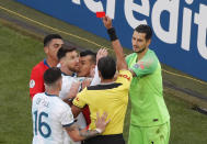 CORRECTS TO SHOWS RED CARD - Referee Mario Diaz shows a red card to Argentina's Lionel Messi and Chile's Gary Medel as they clash during the Copa America third-place soccer match at the Arena Corinthians in Sao Paulo, Brazil, Saturday, July 6, 2019. (AP Photo/Nelson Antoine)