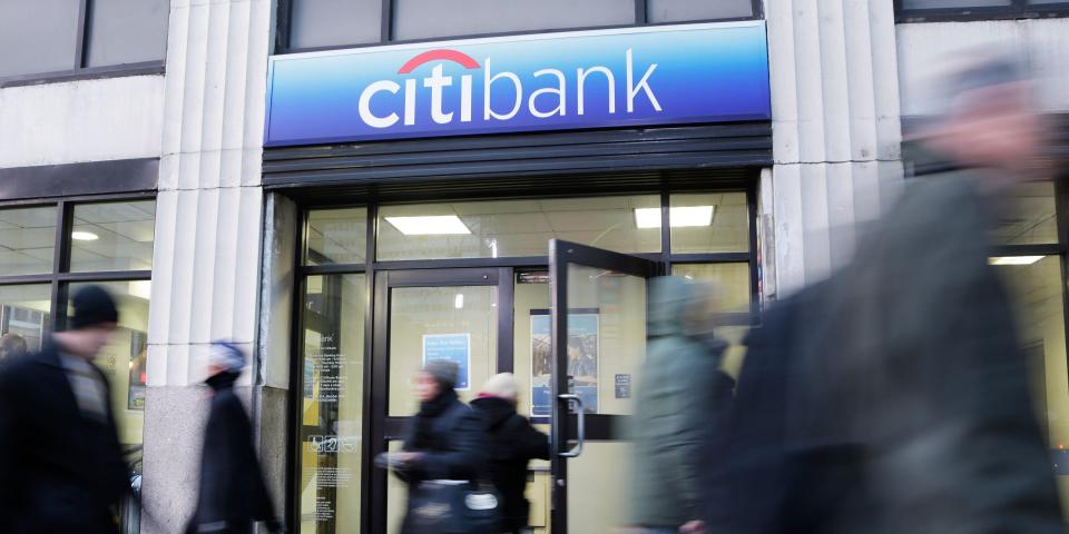 People walk in front of a Citibank