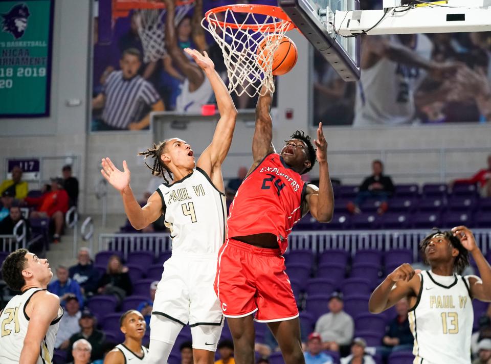 Columbus Explorers forward Malik Abdullahi (24) goes for a dunk as Paul VI Panthers guard Isaiah Abraham (4) goes to block it during the first half of the City of Palms Classic semifinal game at Suncoast Arena in Ft. Myers on Tuesday, Dec. 20, 2022. 