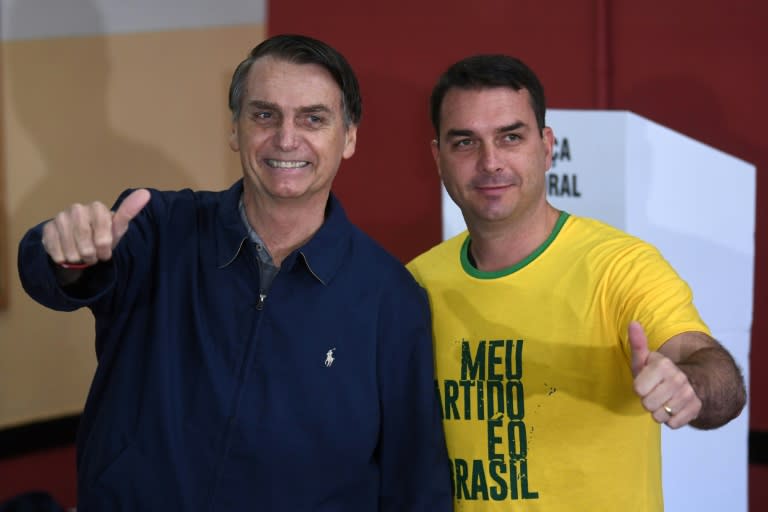 Jair Bolsonaro (L) poses with his son Flavio during the election campaign, in which Flavio romped to a seat in the Senate while Bolsonaro won the presidency