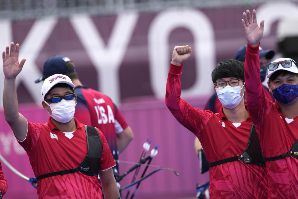 Japan's Yuki Kawata, Hiroki Muto, Takaharu Furukawa, celebrate after winning the men's team quarterfinal match against the United States at the 2020 Summer Olympics, Monday, July 26, 2021, in Tokyo, Japan. (AP Photo/Alessandra Tarantino)