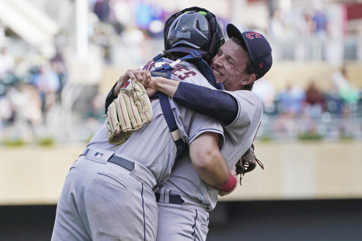 Cleveland Guardians pitcher James Karinchak, right, and catcher Austin Hedges celebrate after they defeated the Minnesota Twins in a baseball game, Sunday, Sept 11, 2022, in Minneapolis. (AP Photo/Jim Mone)