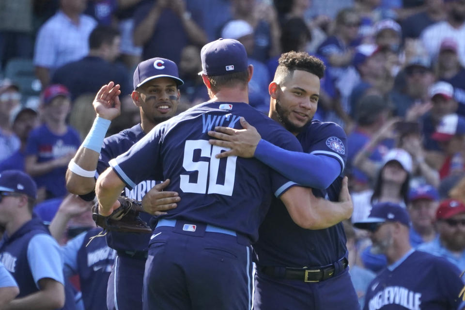 Chicago Cubs' Christopher Morel, left, Willson Contreras, right, celebrate with Chicago Cubs relief pitcher Rowan Wick the team's 2-1 win over the Miami Marlins after a baseball game Friday, Aug. 5, 2022, in Chicago. (AP Photo/Charles Rex Arbogast)