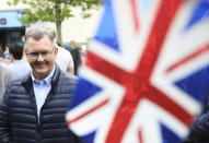 Jeffrey Donaldson leader of the Democratic Unionist Party smiles while out canvassing in Holywood on the outskirts of Belfast, Northern Ireland, Monday, May 2, 2022. The DUP leader was out election campaigning ahead of Thursday's local election. (AP Photo/Peter Morrison)