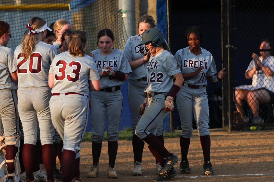 Tates Creek’s Tinley Easton (22) steps on home plate as her teammates celebrate her home run at Lexington Christian Academy on Tuesday.