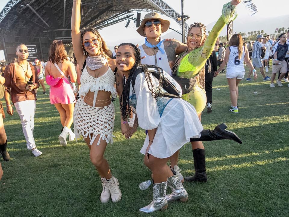 Group of people poses at Coachella wearing festival outfits