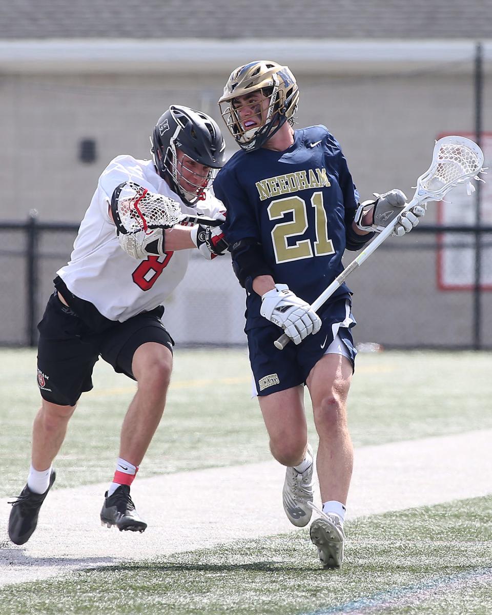 Hingham's Connor Hartman pushes Needham's John Hood out of bounds forcing a turnover during fourth quarter action of their game against Needham at Hingham High School on Saturday, April 9, 2022.