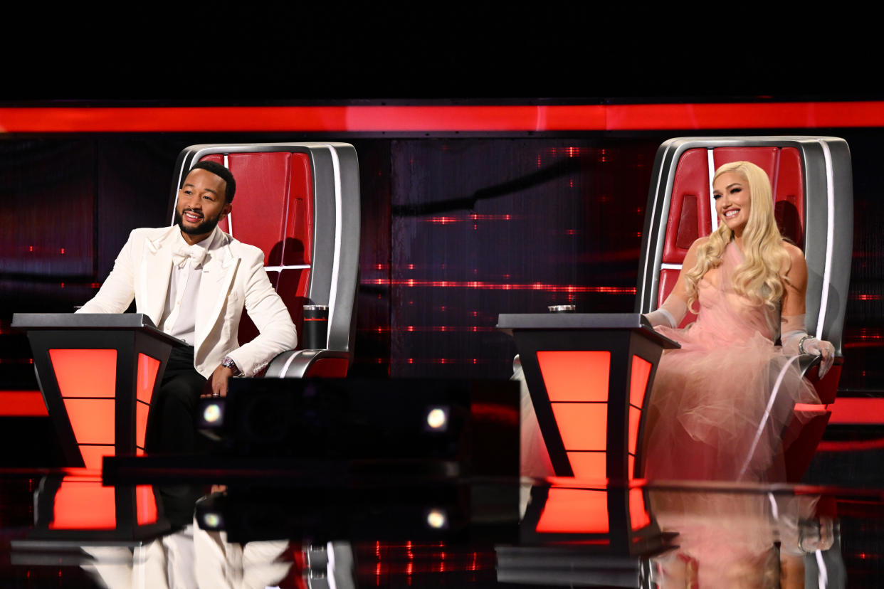 John Legend and Gwen Stefani sitting in their coach's chairs on The Voice.